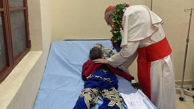 Cardinal Pietro Parolin with a sick child at the Usratuna center for disabled persons