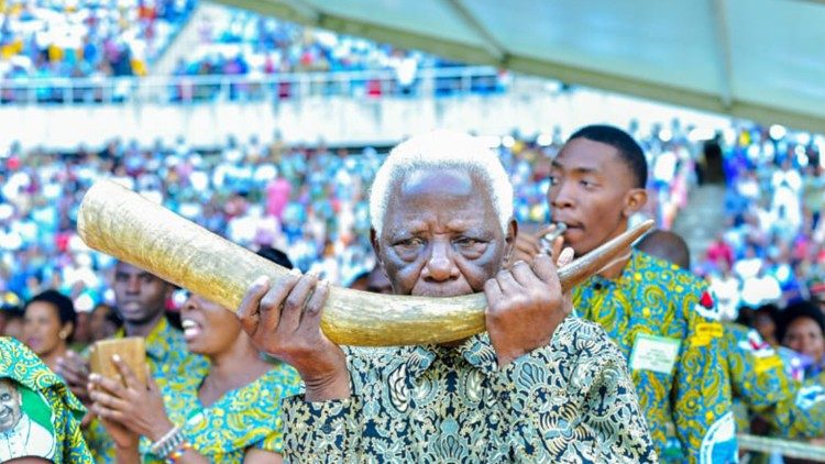 A man blows a handmade horn