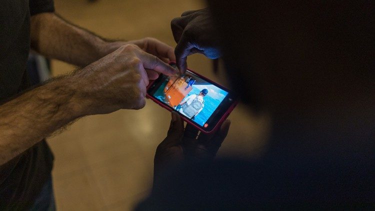 Roman Ebimene relives through mobile phone footage the moment he and three other Nigerians were rescued after 14 days hiding in the stern of a cargo ship (Photo copyright: Giovanni Culmone/Global Solidarity Fund).